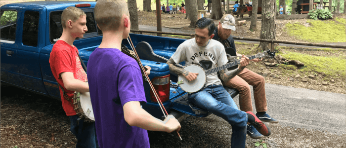 Musicians gather on the back of a truck@2x